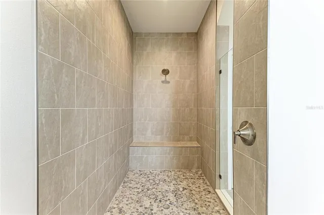a bathroom with a glass door shower
