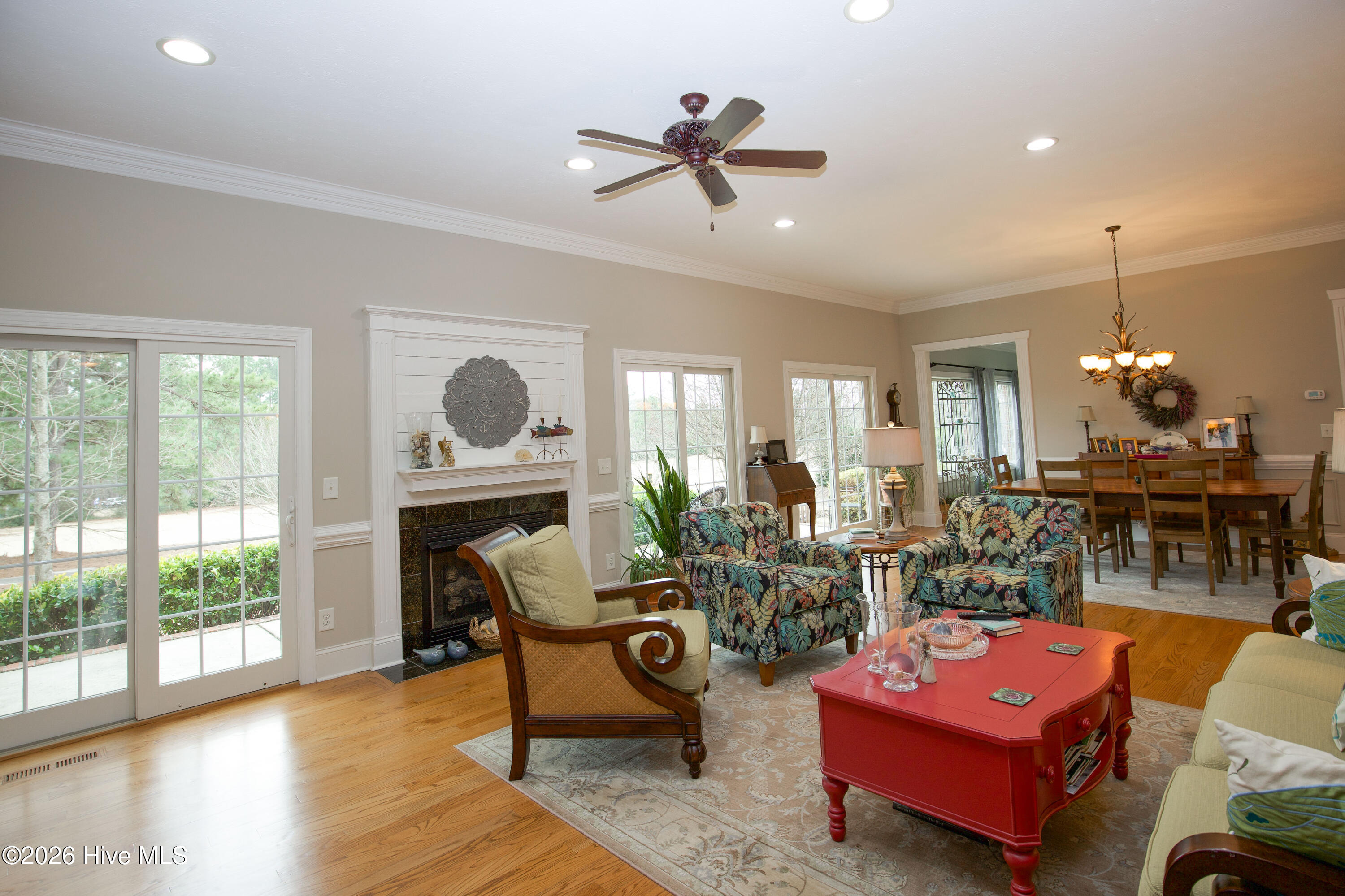 45 Richmond Road Jackson Springs, NC 27281 - Photo 12 of 93 Another view of the great room at 45 Richmond Rd in Foxfire Village highlights the open layout, vaulted ceiling, and elegant architectural features. This spacious gathering area is perfect for both entertaining and everyday living, with abundant natural light, rich hardwood flooring, and seamless flow to the dining and kitchen areas. A comfortable and stylish heart of the home.