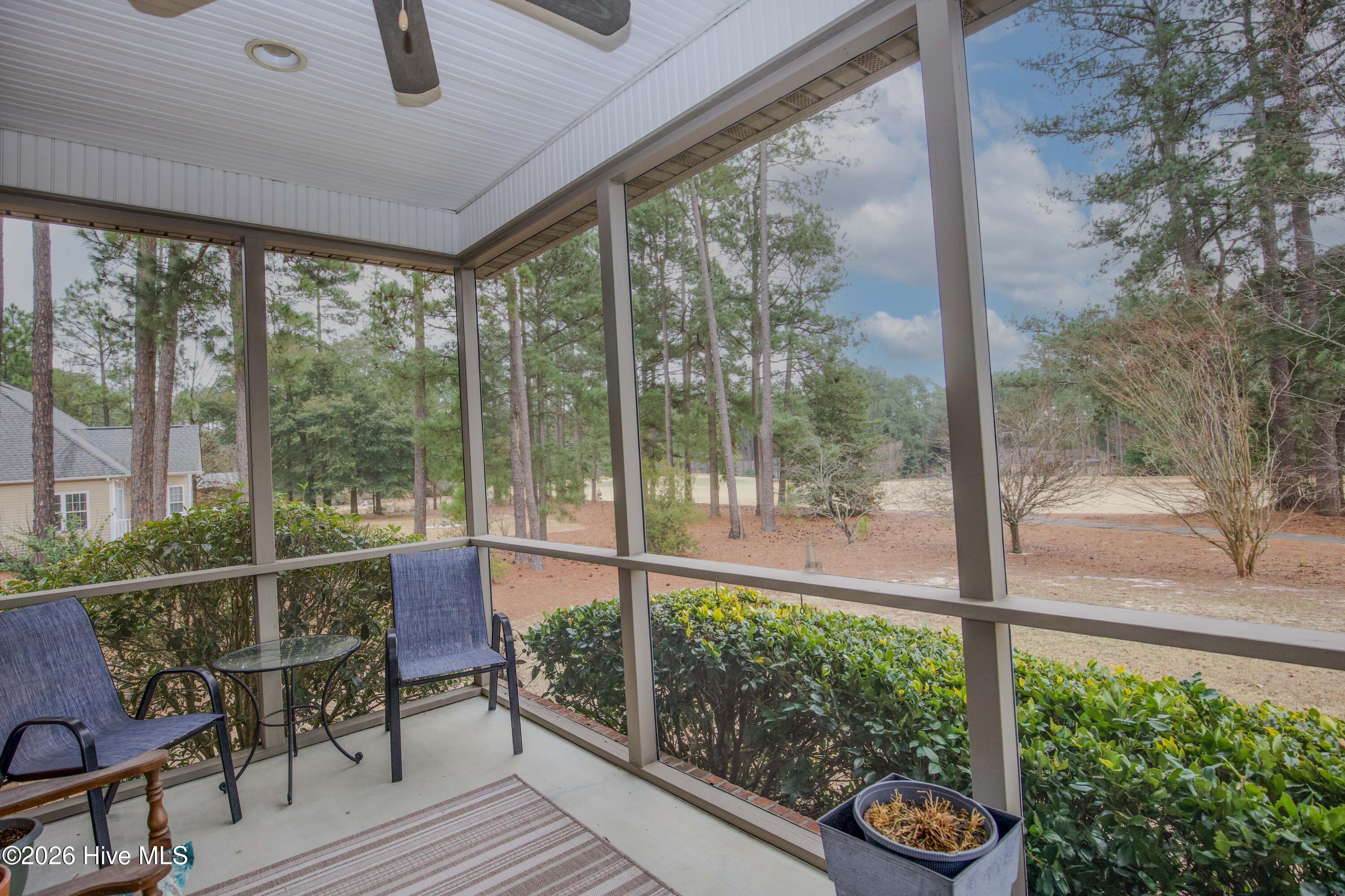 45 Richmond Road Jackson Springs, NC 27281 - Photo 32 of 93 Enjoy serene golf course views from this peaceful screened-in porch, tucked privately off the primary suite. With ceiling fan above and ample space for seating, it’s the perfect spot to unwind and soak in the natural beauty year-round.