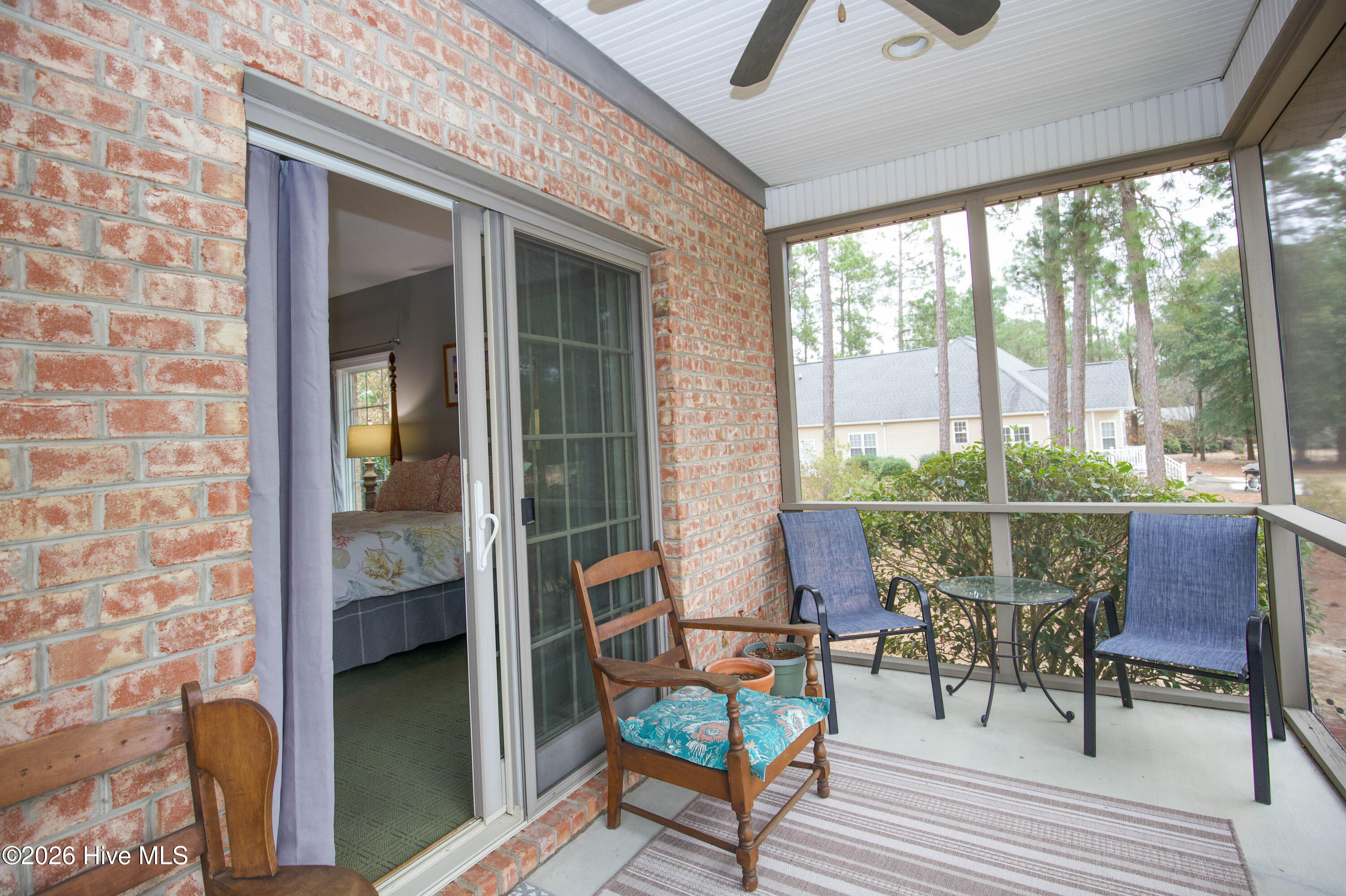 45 Richmond Road Jackson Springs, NC 27281 - Photo 34 of 93 Step directly from the primary suite onto your private screened-in porch—an ideal retreat with ceiling fan, seating space, and lush golf views. This peaceful outdoor nook offers seamless access to the rear deck while blending comfort and privacy.