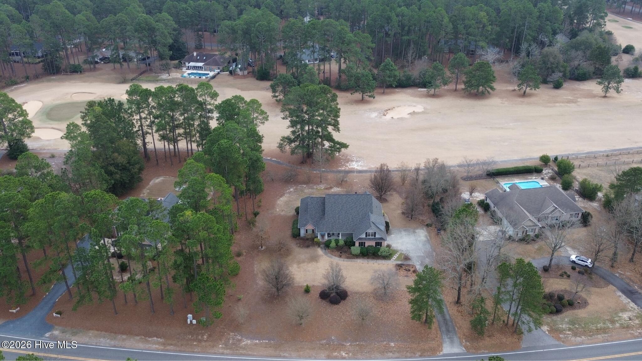 45 Richmond Road Jackson Springs, NC 27281 - Photo 4 of 93 A stunning aerial view of 45 Richmond Rd shows its prime location backing up to the Red Fox Course in Foxfire Village. With a spacious lot, beautiful mature landscaping, and direct golf course access, this home offers the perfect blend of privacy and views in a peaceful, natural setting.