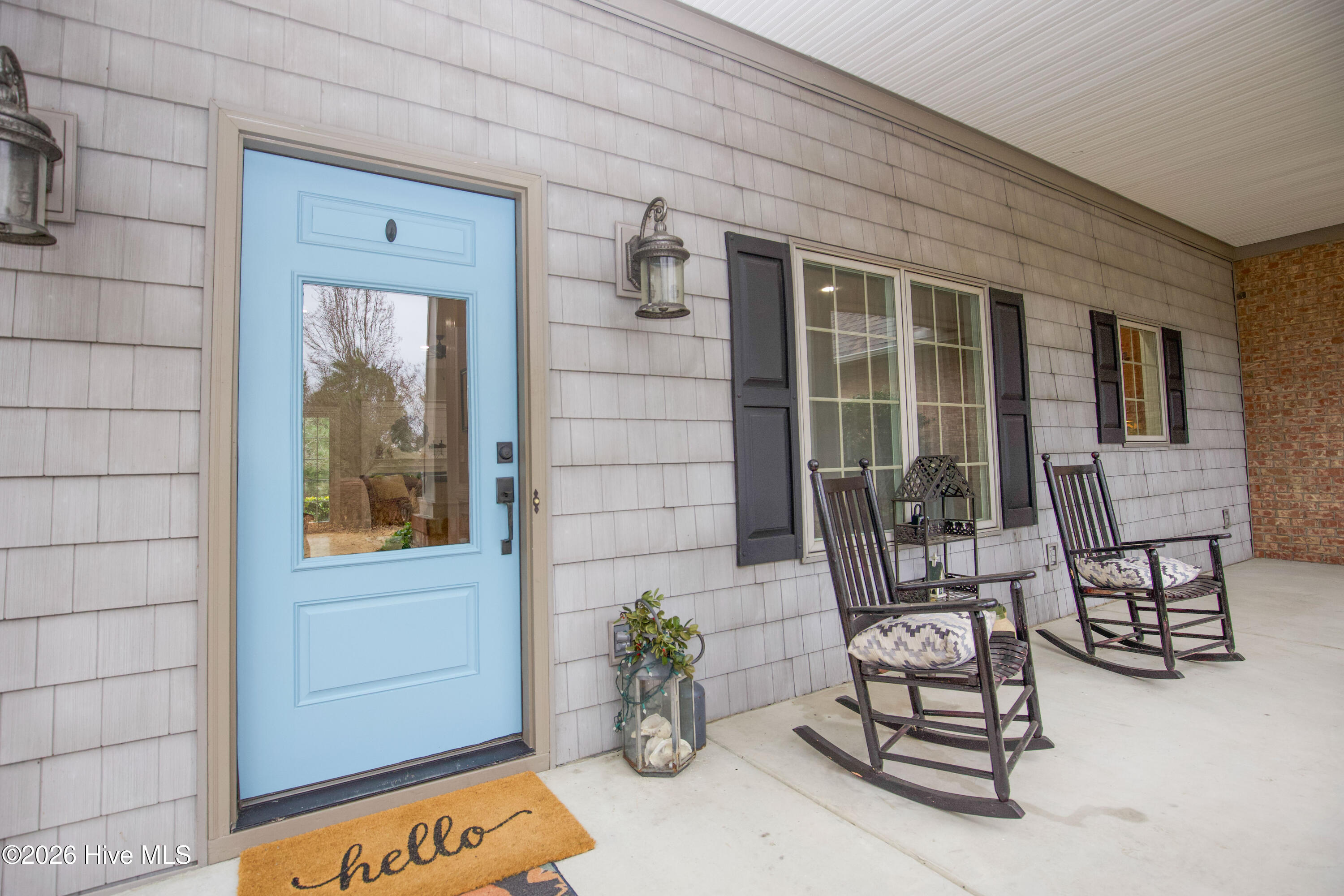 45 Richmond Road Jackson Springs, NC 27281 - Photo 6 of 93 Charming details welcome you at 45 Richmond Rd, including a cheerful blue front door, cozy rocking chairs, and lantern lighting. The covered front porch is perfect for relaxing and greeting guests, all set beneath a brand new roof that enhances the home’s curb appeal.