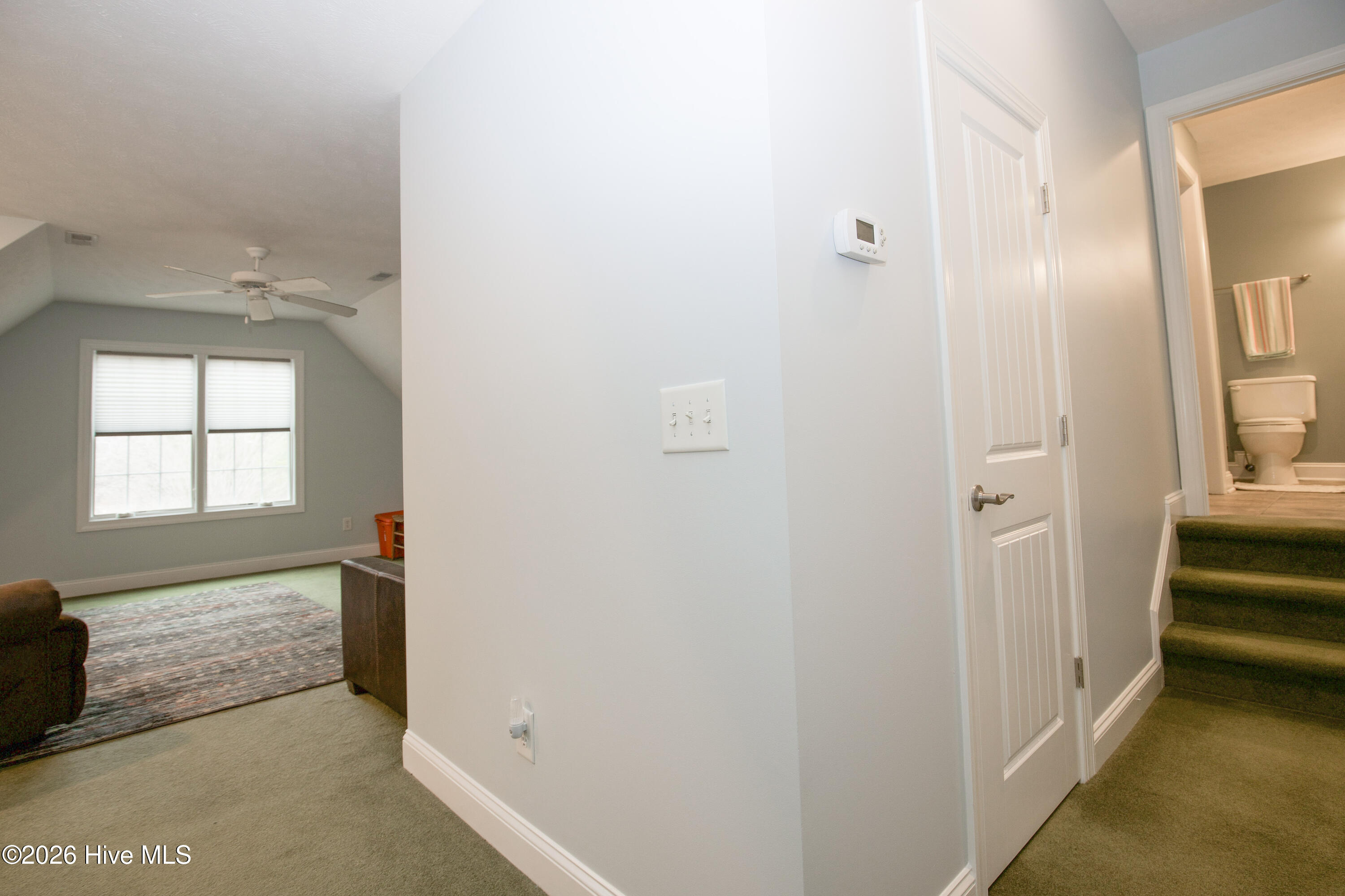 45 Richmond Road Jackson Springs, NC 27281 - Photo 63 of 93 A dedicated entrance leads to another spacious upstairs bedroom, currently used as a cozy sitting area. With its own sense of privacy and direct access to a nearby full bathroom, this flexible space is ideal for use as a bedroom, home office, or media room.