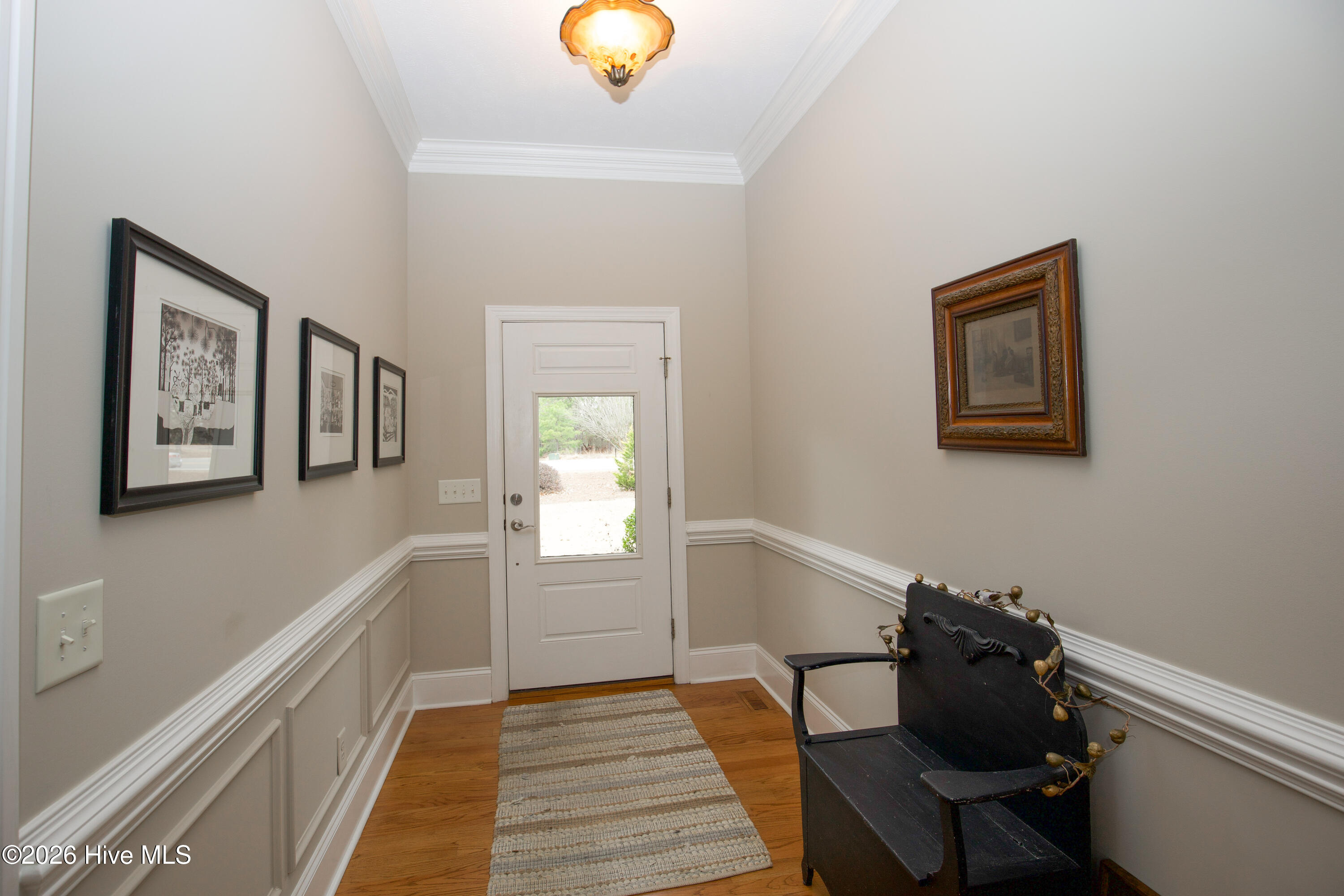 45 Richmond Road Jackson Springs, NC 27281 - Photo 7 of 93 From the entry foyer of 45 Richmond Rd in Foxfire Village, enjoy this elegant front-facing view that welcomes guests with warmth and charm. The light-filled space showcases beautiful hardwood floors, detailed trim work, and a layout that flows seamlessly throughout the home. This inviting entrance sets the tone for comfortable living and thoughtful design in this golf-front property.