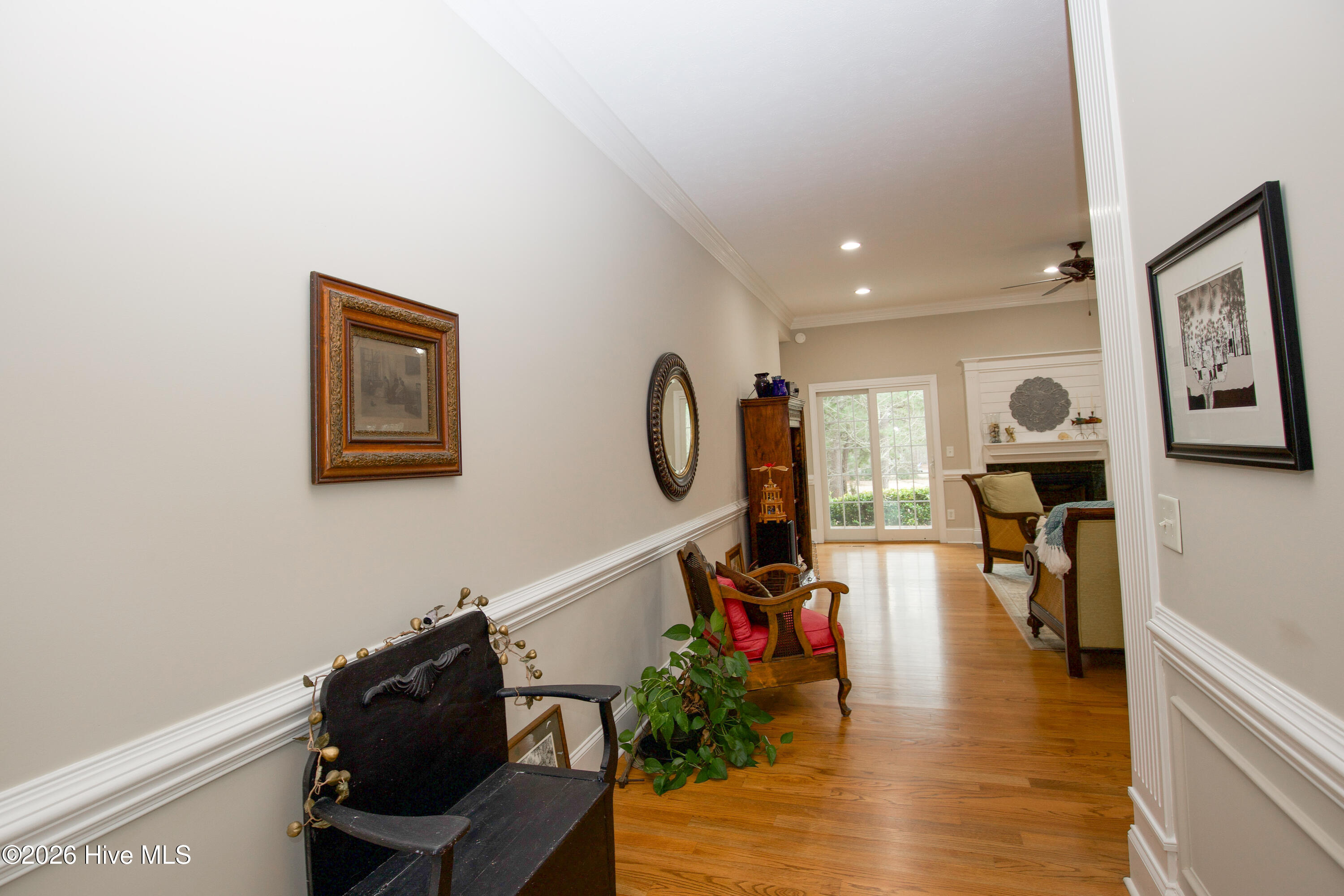 45 Richmond Road Jackson Springs, NC 27281 - Photo 9 of 93 Step into 45 Richmond Rd in Foxfire Village and enjoy this elegant view from the spacious foyer. The open layout reveals a warm and inviting living space with hardwood floors, crown molding, and abundant natural light. A perfect blend of comfort and style, this front-facing perspective highlights the home's welcoming charm and thoughtful design ideal for everyday living and entertaining.