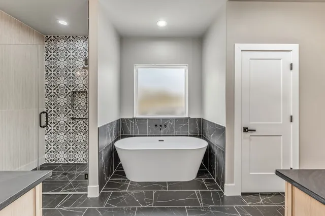 a bathroom with a double vanity sink a mirror and a shower