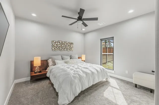 a view of an empty room with a ceiling fan
