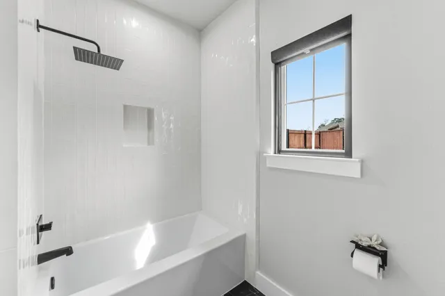 a bathroom with a granite countertop toilet sink and mirror