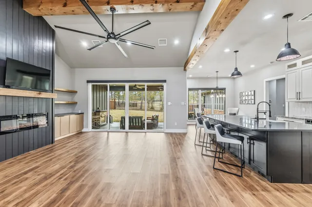 a view of a kitchen with furniture and wooden floor