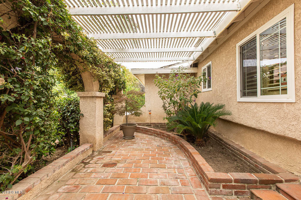 4238 Adam Road Simi Valley, CA 93063 - Photo 2 of 35 a porch with a bench and potted plants