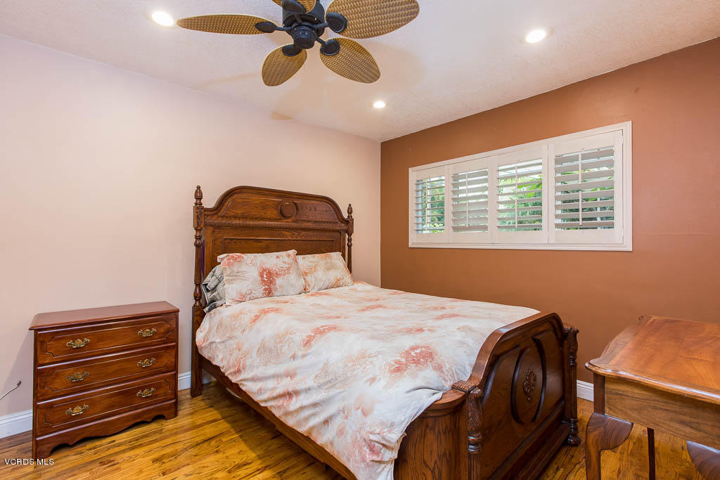 4238 Adam Road Simi Valley, CA 93063 - Photo 12 of 35 a bedroom with a bed and a chandelier