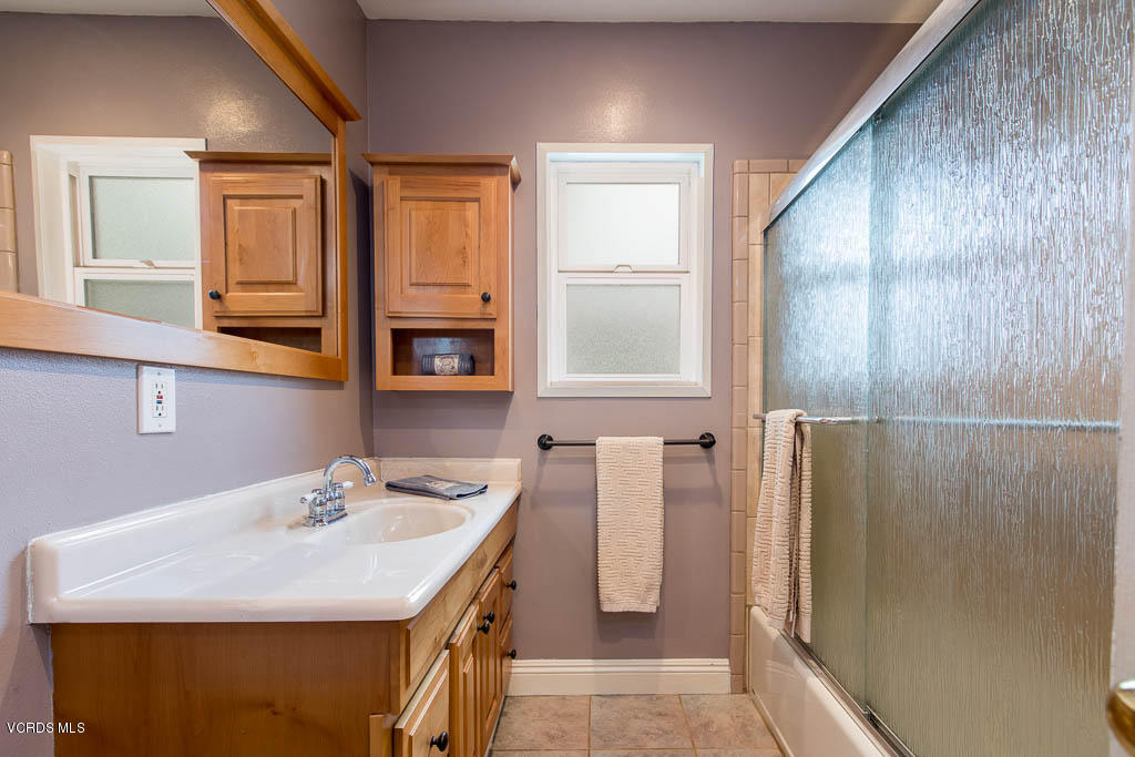 4238 Adam Road Simi Valley, CA 93063 - Photo 16 of 35 a bathroom with a sink a mirror and a shower