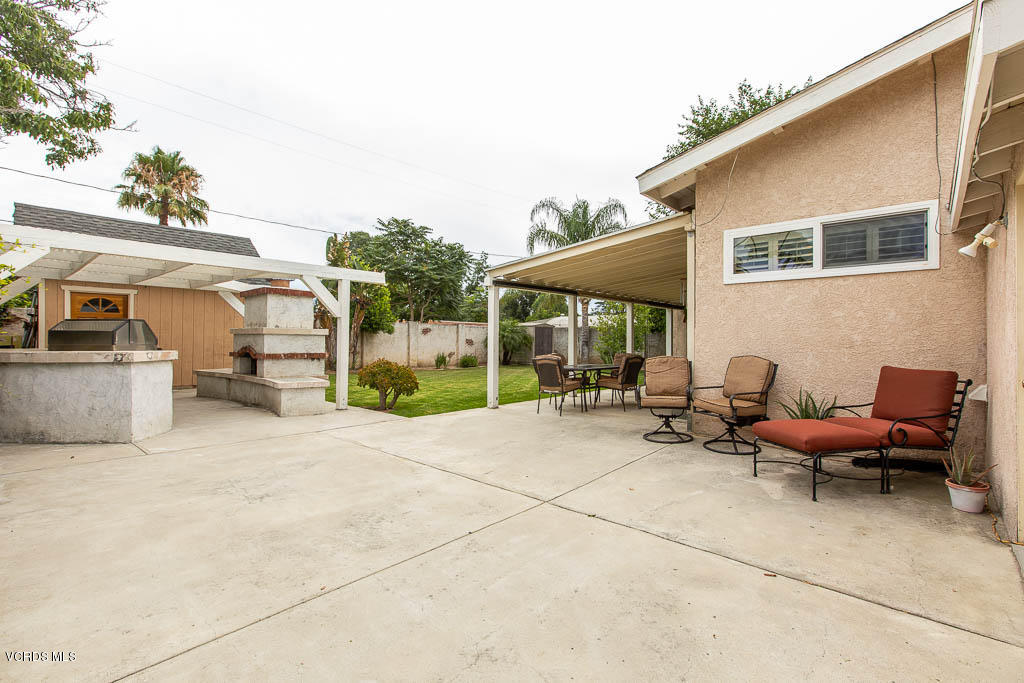 4238 Adam Road Simi Valley, CA 93063 - Photo 24 of 35 a view of a patio with a table and chairs under an umbrella