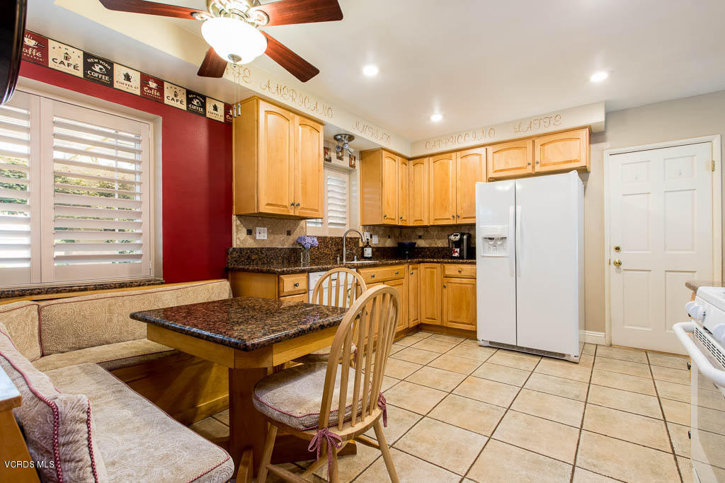 4238 Adam Road Simi Valley, CA 93063 - Photo 4 of 35 a kitchen with granite countertop a stove a sink dishwasher and a refrigerator with wooden floor