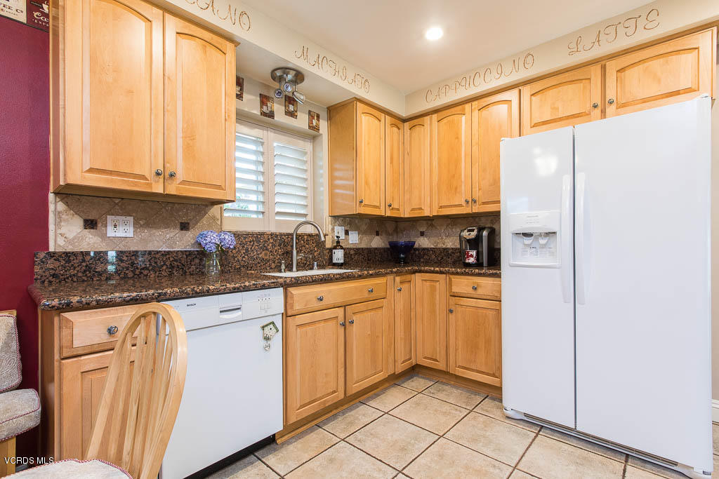 4238 Adam Road Simi Valley, CA 93063 - Photo 5 of 35 a kitchen with stainless steel appliances granite countertop a refrigerator and white cabinets