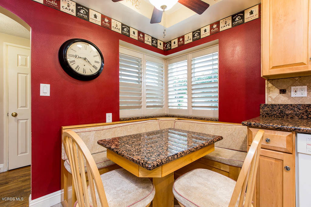 4238 Adam Road Simi Valley, CA 93063 - Photo 7 of 35 a kitchen with a table a clock and a clock