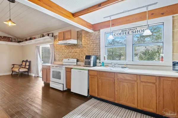 a kitchen with a sink cabinets and wooden floor