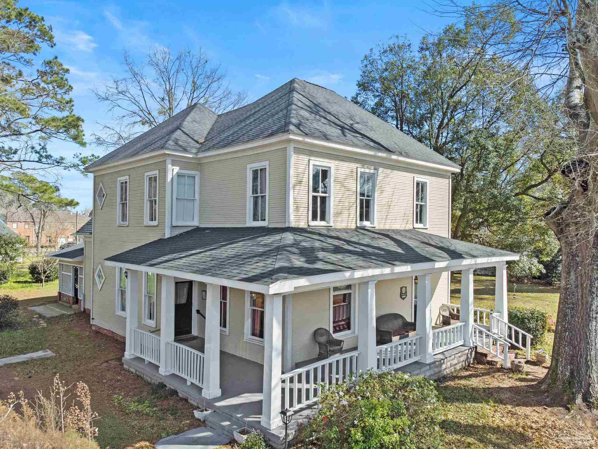 309 South Main Street Atmore, AL 36502 - Photo 2 of 47 a front view of a house with a yard outdoor seating and pathway