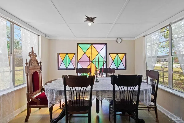 a view of a dining room with furniture large windows and wooden floor