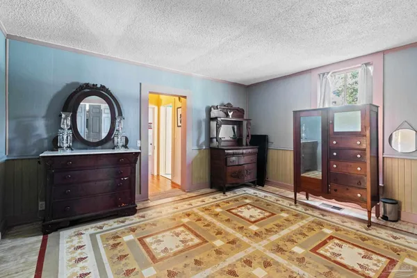 a view of a bedroom with furniture cabinet and windows