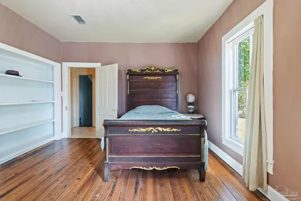 a view of a hardwood floor and wardrobe