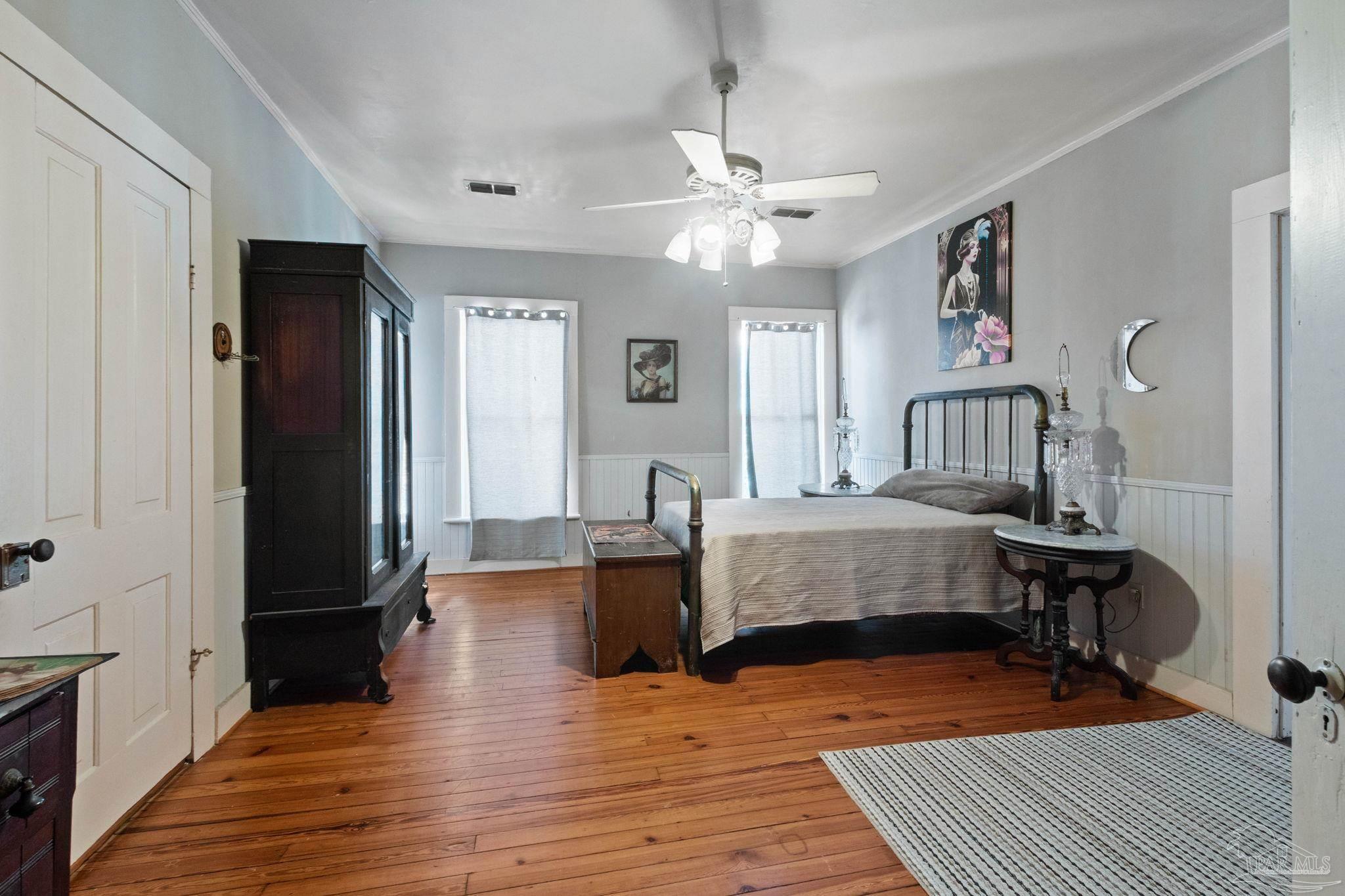 309 South Main Street Atmore, AL 36502 - Photo 30 of 47 a bedroom with wooden floor and a chandelier