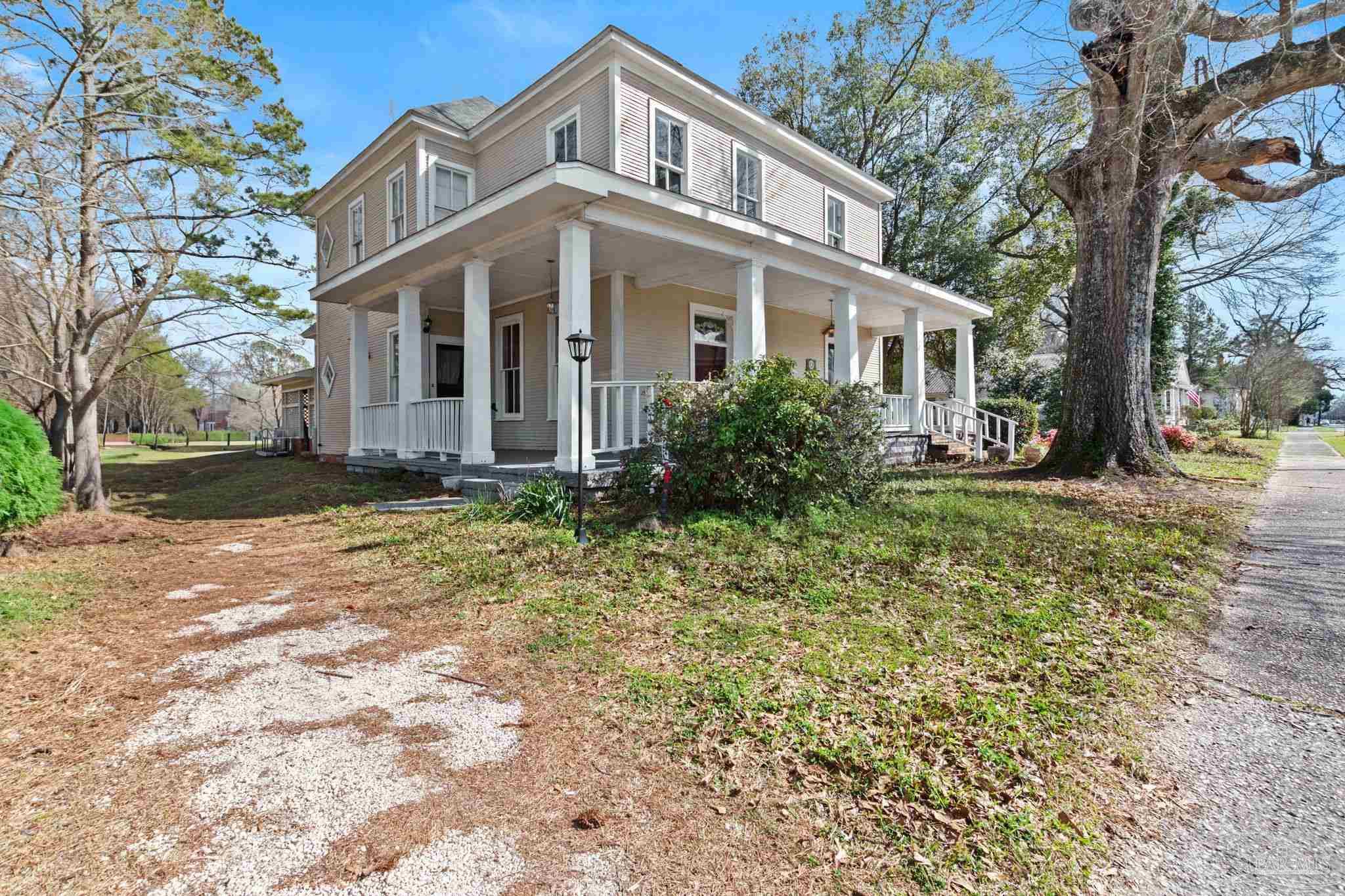 309 South Main Street Atmore, AL 36502 - Photo 3 of 47 a front view of a house with garden