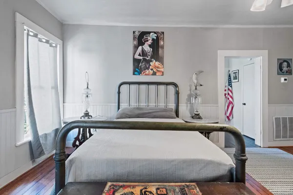 a bedroom with a bed and a window