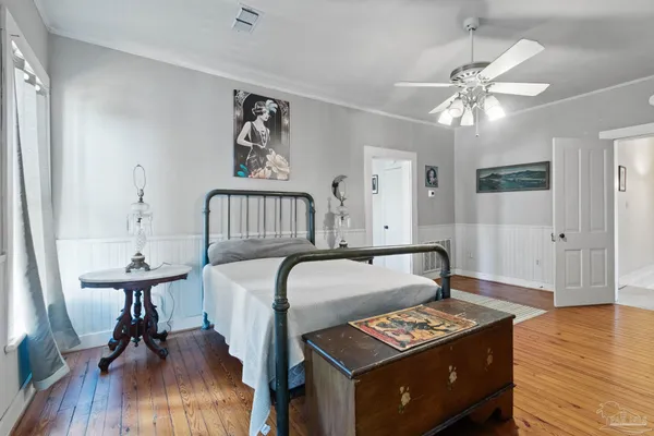 a bedroom with furniture and a wooden floor