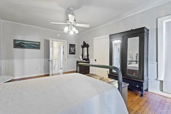 a bedroom with a large bed and a chandelier