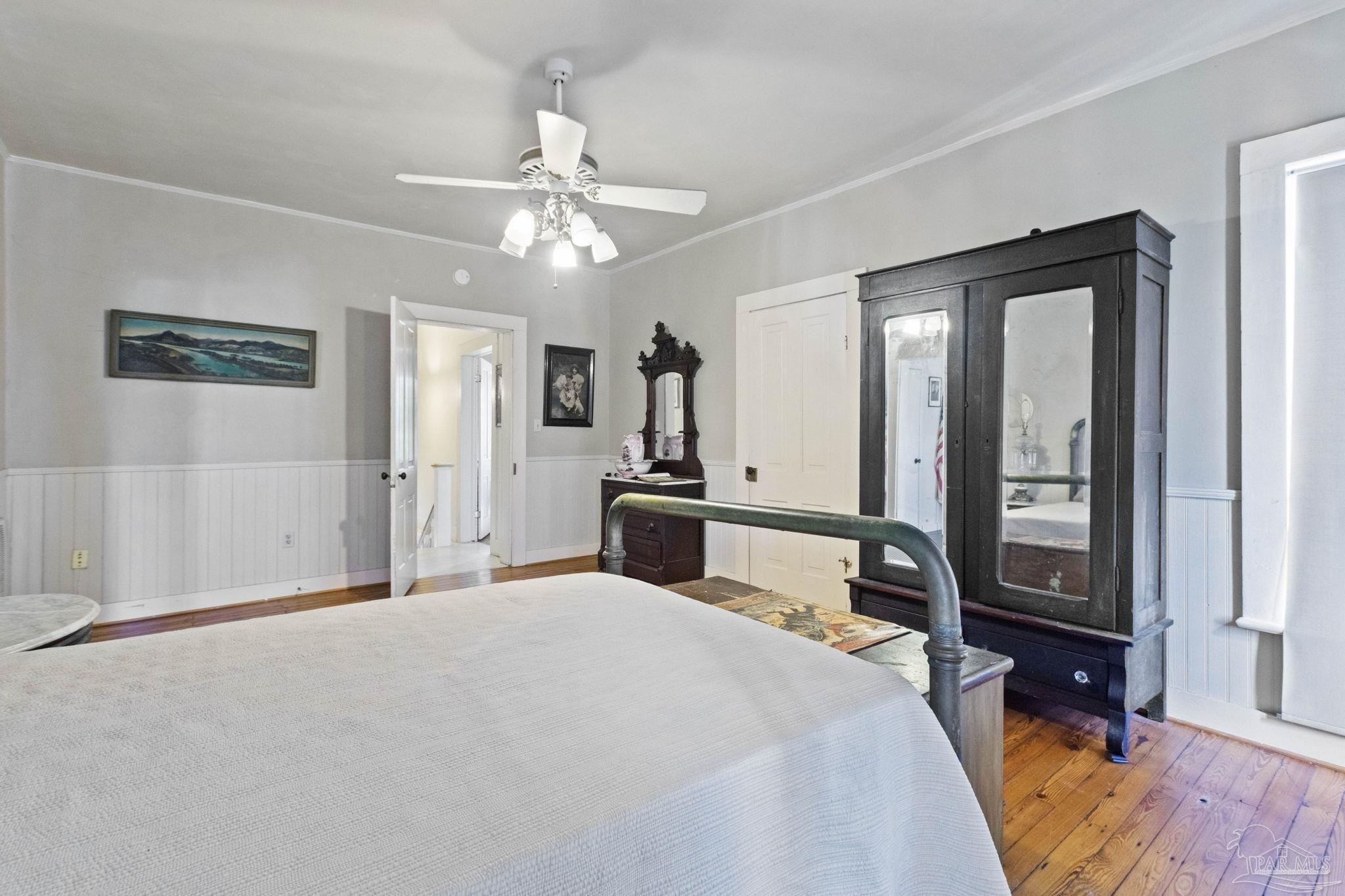 309 South Main Street Atmore, AL 36502 - Photo 33 of 47 a bedroom with a large bed and a chandelier