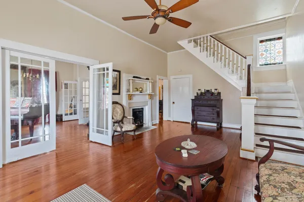 a living room with furniture a fireplace and wooden floor