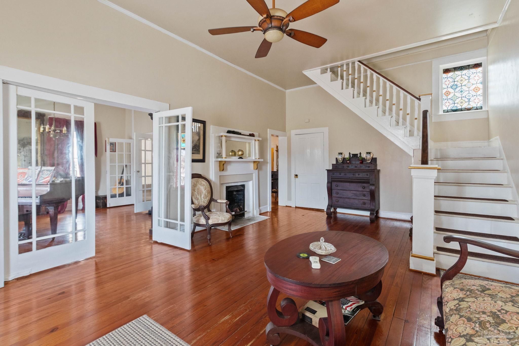 309 South Main Street Atmore, AL 36502 - Photo 6 of 47 a living room with furniture a fireplace and wooden floor