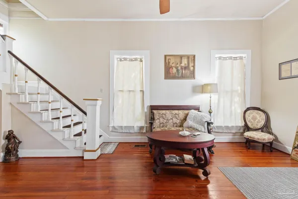 a living room with furniture and wooden floor
