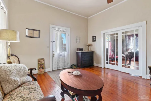 a living room with furniture and a wooden floor