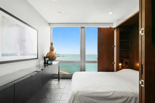 a bedroom with a bed and lamp with window