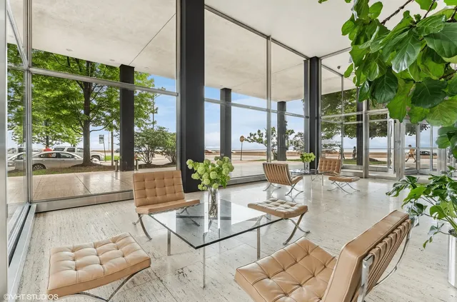 a living room with patio furniture and a garden