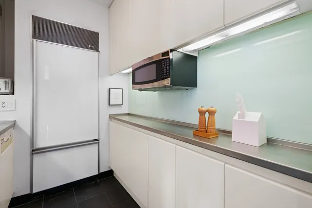 a kitchen with a refrigerator and a sink