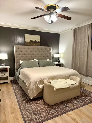 a bedroom with a bed a television and a couch