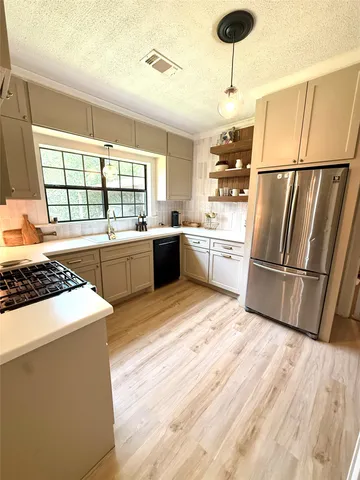 a large kitchen with a large window