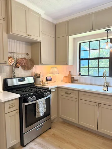 a kitchen with stainless steel appliances a refrigerator and sink