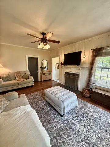 a bedroom with a bed a flat screen tv and a fireplace