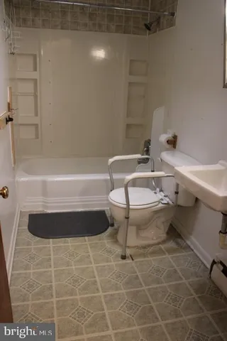a bathroom with a bathtub a sink a toilet and a shower
