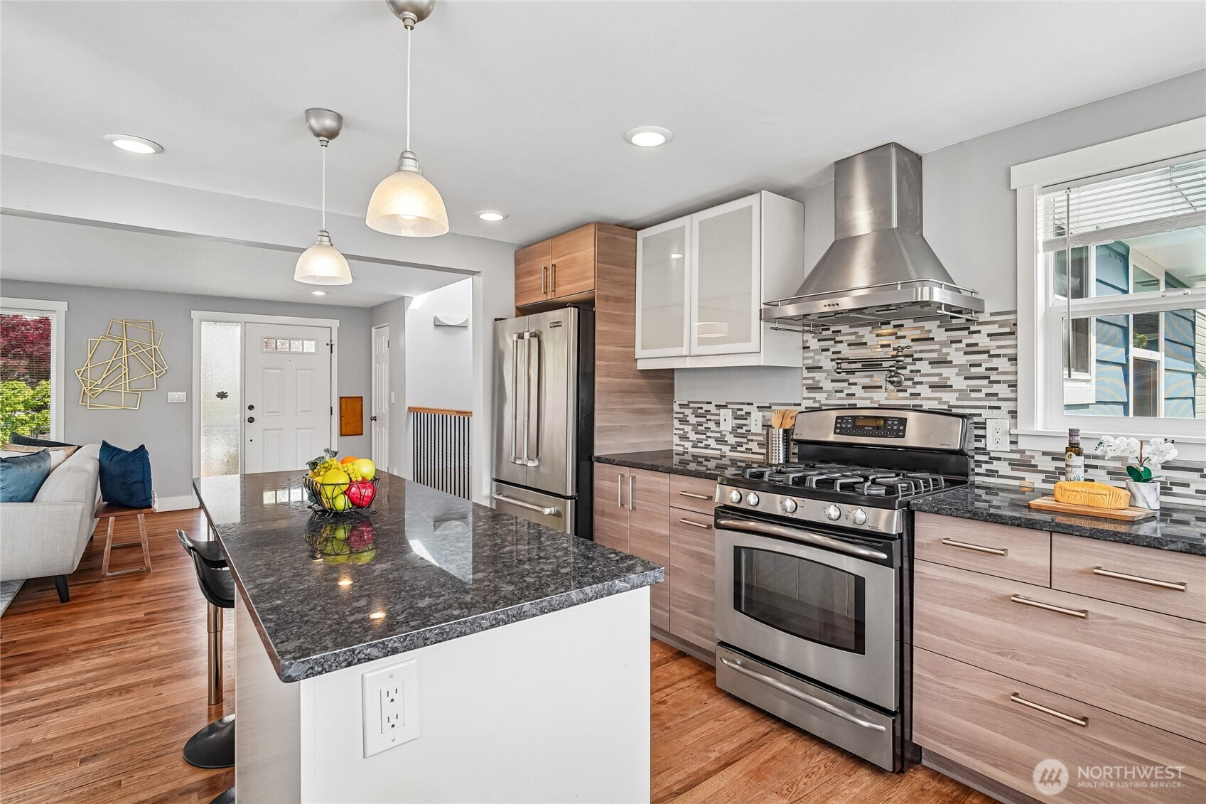 7313 25th Avenue Northwest Seattle, WA 98117 - Photo 11 of 40 a kitchen with stainless steel appliances granite countertop a stove and a refrigerator