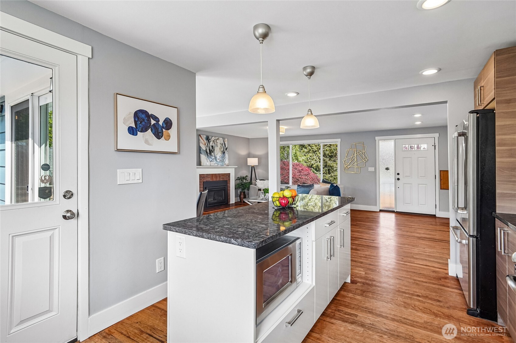 7313 25th Avenue Northwest Seattle, WA 98117 - Photo 12 of 40 a kitchen that has a lot of counter space and wooden floor
