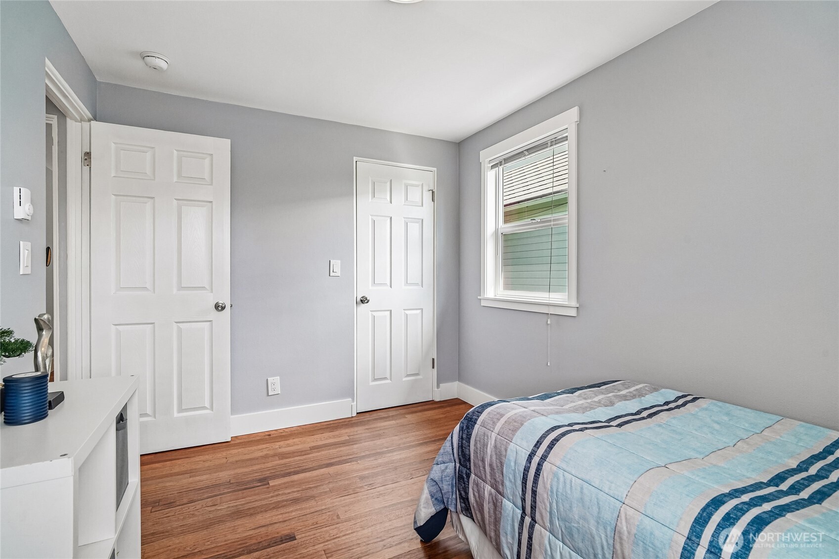 7313 25th Avenue Northwest Seattle, WA 98117 - Photo 15 of 40 a bedroom with a bed and wooden floor