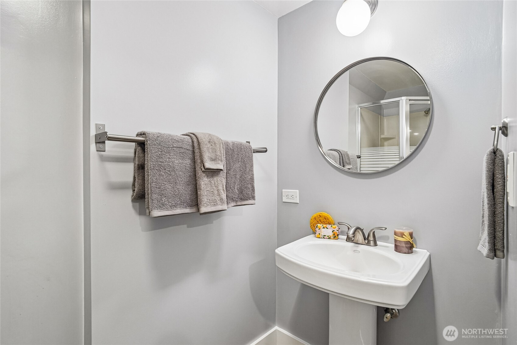 7313 25th Avenue Northwest Seattle, WA 98117 - Photo 18 of 40 a bathroom with a sink and a mirror