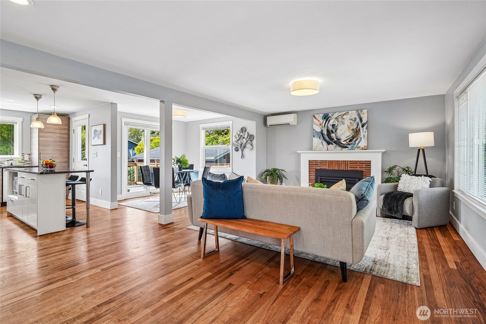 7313 25th Avenue Northwest Seattle, WA 98117 - Photo 2 of 40 a living room with fireplace furniture and a wooden floor