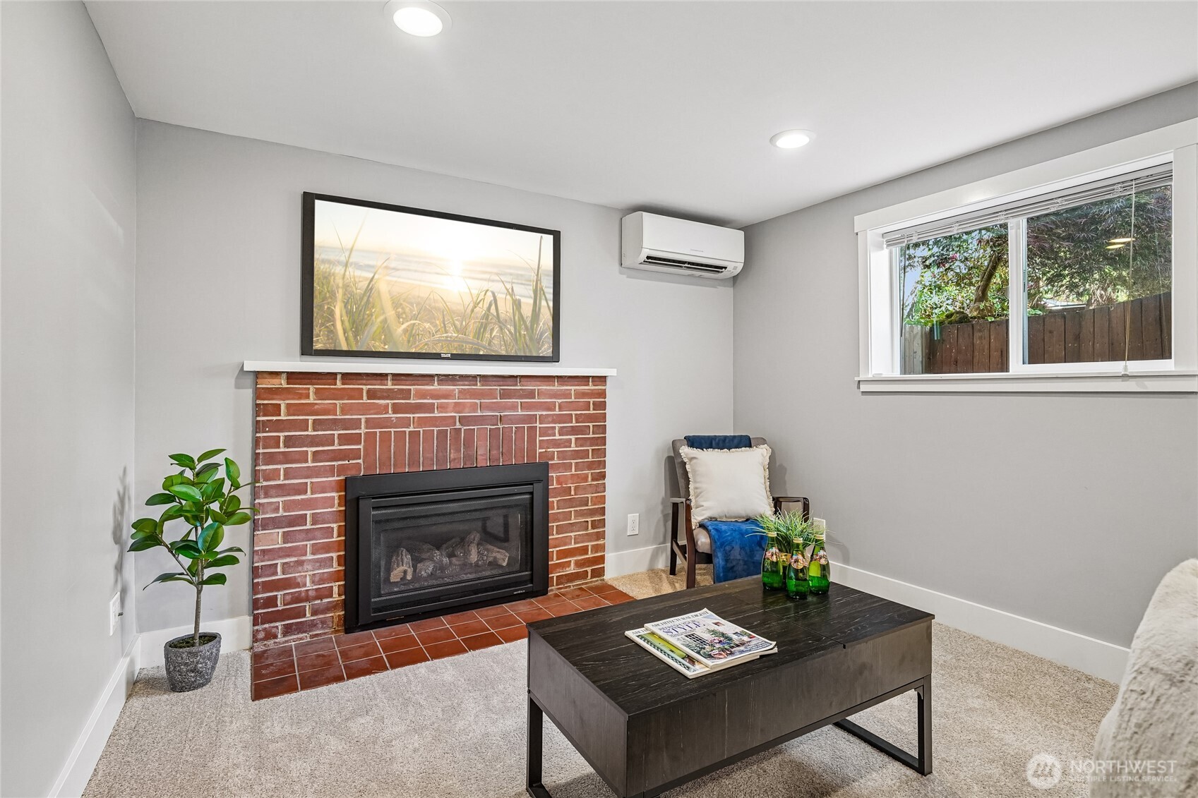 7313 25th Avenue Northwest Seattle, WA 98117 - Photo 22 of 40 a living room with furniture a fireplace and a window