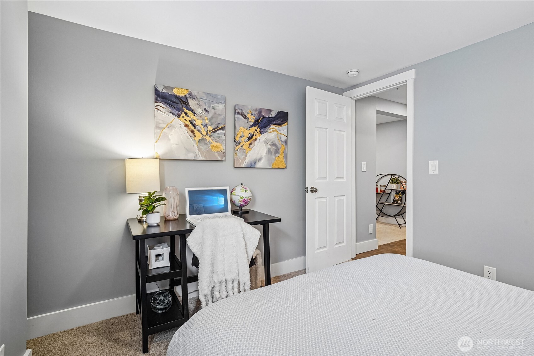 7313 25th Avenue Northwest Seattle, WA 98117 - Photo 26 of 40 a bedroom with a bed and a table in it